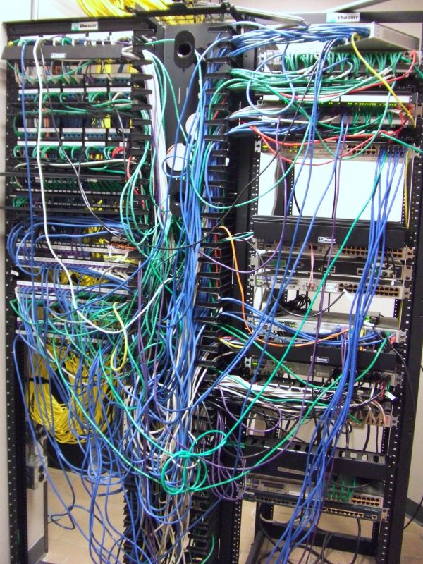 Photo of a networking rack with lots of wires