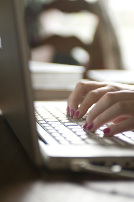 Stock Photo of Female Hands Typing On A Laptop Keyboard