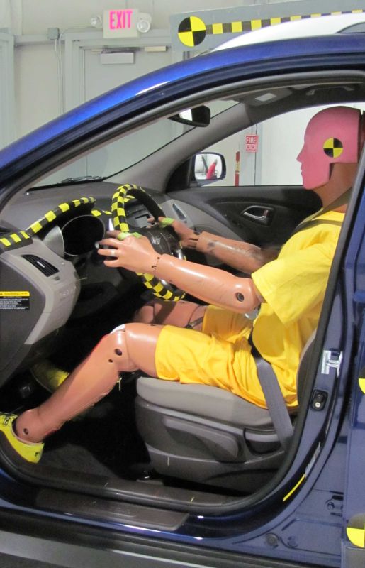 Photo from wikimedia commons of a crash test dummy in a car
